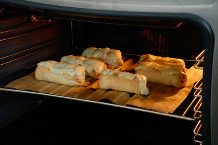 Morning breakfast: sausages covered with dough in hot oven. Pastry that have good taste and fresh. Tasty breakfast or homemade lunch concept.の写真素材