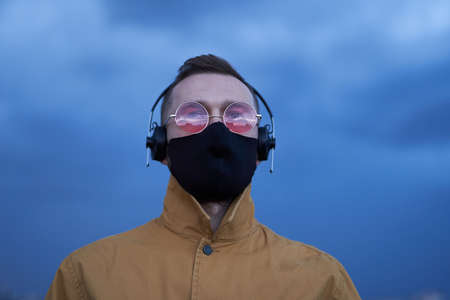 Concept of listening to the music, new album or soundtrack. Beautiful caucasian man in pink...