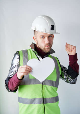 St. Valentines Day: dancing bearded male construction worker or technician in hard hat and...
