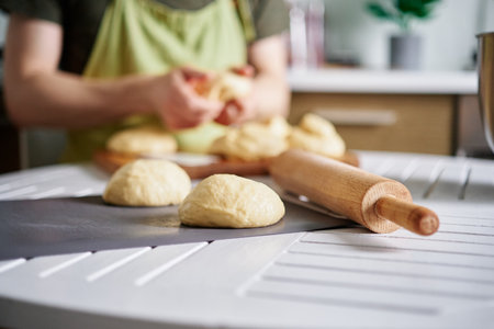 Dough balls preparation concept. Unrecognizable baker working with dough on background, Fresh raw...