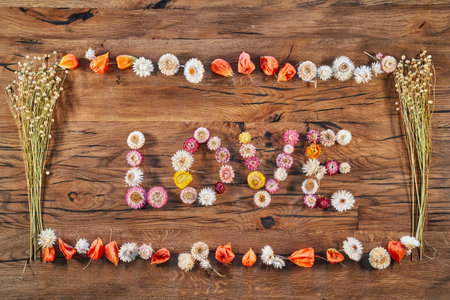 Top view of wooden table with harvesting season composition ant text Love inside it. Harvesting organic products. High quality imageの写真素材
