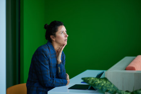 Portrait of a business woman sitting thing by the laptop High quality photo