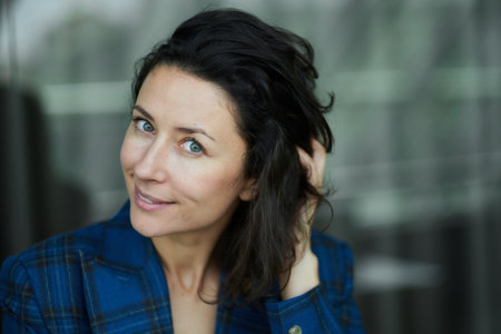 Portrait of a business woman smiling and happy. Dark blue jacket, confident woman looking in the camera High quality photoの写真素材