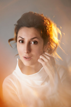 Closeup female portrait concept. Emotional looking young caucasian woman with beautiful hair on grey background. High quality vertical photoの写真素材