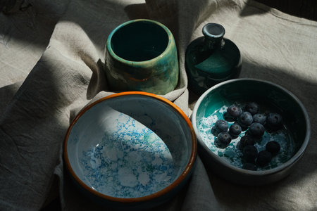 Set of kitchen ceramic tableware and wooden cutting boards on a table. Eco style home still life. High quality photoの写真素材
