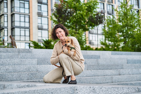 Girl kissing hugging dog pet cute adorable red dog friendly closeup closing eyes funny animals. High quality photoの写真素材