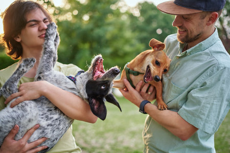 Support, care or happy family, men and kids bonding with foster puppy or pet and enjoying time together. High quality photoの写真素材