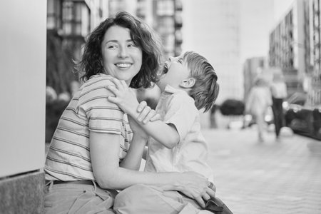 Adorable mother and son smiling happy having fun at city background. Motherhood concept, hugging....