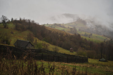 Foggy morning landscape with mountain range and misty forest, amazing autumn sunrise. Carpathian mountains, Ukraine. Panoramic view. High quality photoの写真素材
