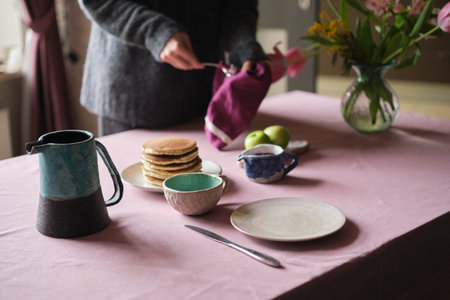Simple pancake breakfast with jam and apple, tea served on a kitchen table. Simple life concept High quality photoの写真素材
