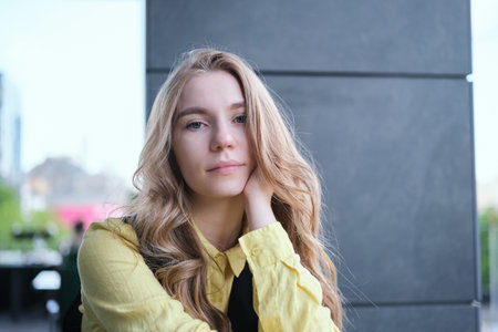 Portrait of a attractive young positive adult female on the business background. Student, business woman, services. High quality photoの写真素材