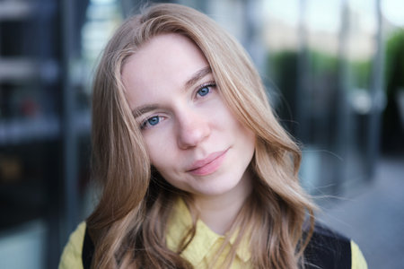 Portrait of a attractive young positive adult female on the business background. Student, business woman, services. High quality photoの写真素材