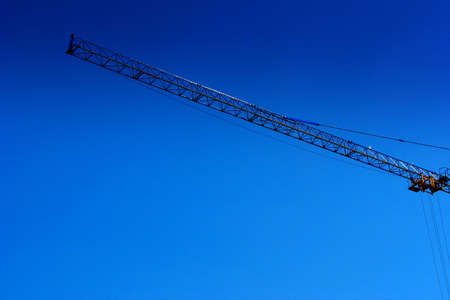 Part of crane with blue, springer sky in the background. の写真素材