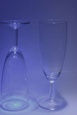 Two of the same glasses of wine on the blue background.の写真素材
