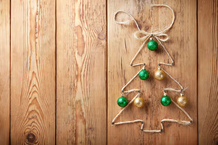 Christmas tree with balls on wooden background with copy spaceの写真素材