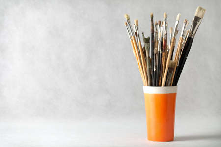 Art paint brushes in cup with empty room for textの写真素材
