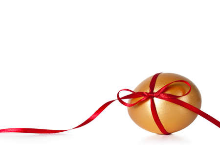 Easter egg with red ribbon on white backgroundの写真素材