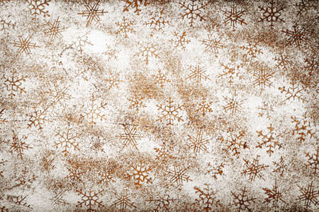 Snowflake pattern made %u200B%u200Bof icing sugar on wooden tableの写真素材