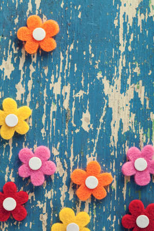Spring colorful felt flowers on wood background. の写真素材