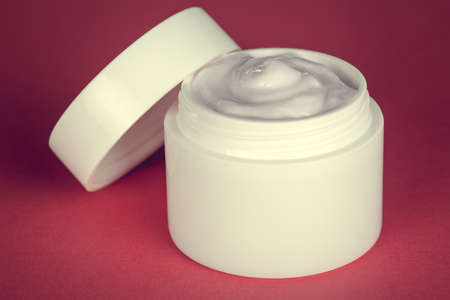 Beauty face cream container on pink backgroundの写真素材