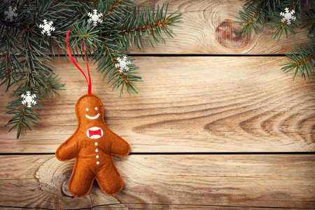 Christmas background with spruce tree and gingerbread man on wooden table. Copy space. Top viewの写真素材