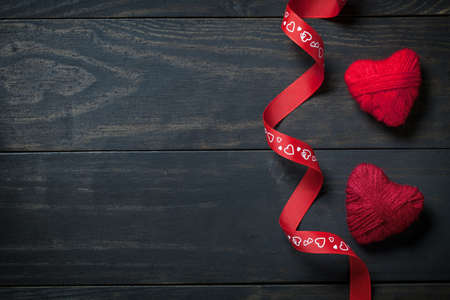 Red hearts made of wool on wooden background for Valentine's Day. Copy space. Top viewの写真素材