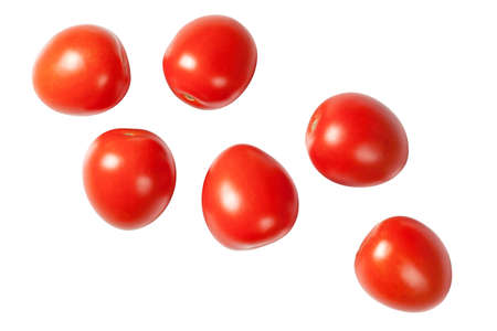 Falling plum tomatoes isolated on white background. Top viewの写真素材