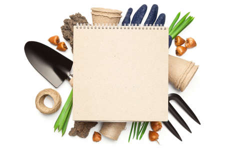 Gardening concept. Blank notebook over gardening tools isolated on white background. Copy space. Top viewの写真素材