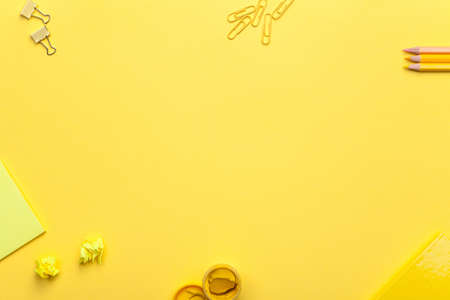 School accessories on yellow background. Minimal style. Flat lay. Copy space. Top viewの写真素材