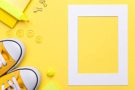 Back to school concept. School accessories with white frame on yellow background. Flat lay. Copy space. Top viewの写真素材