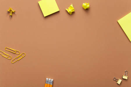 School accessories on brown background. Minimal style. Flat lay. Copy space. Top viewの写真素材