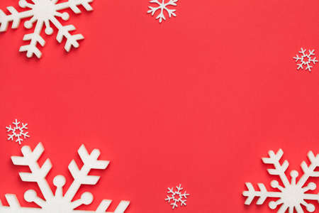 Christmas background with snowflakes on red paper. Copy space. Top viewの写真素材