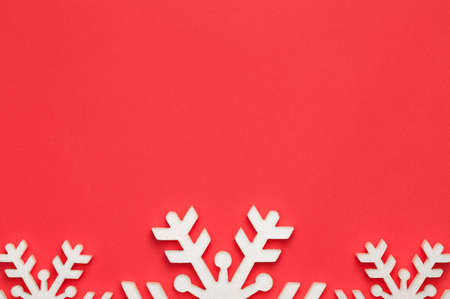 Christmas background with snowflakes on red paper. Copy space. Top viewの写真素材