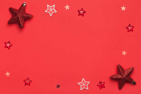 Christmas composition with stars on red paper background. Copy space. Top viewの写真素材