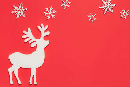 Christmas background with reindeer and snowflakes on red paper. Top viewの写真素材