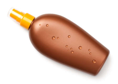 Suntan oil bottle with water drops isolated on white background. Top viewの写真素材