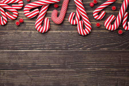Christmas composition with candy canes on wooden background. Copy space. Top viewの写真素材