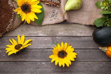 Autumn background with sunflowers on wooden table. Top viewの写真素材