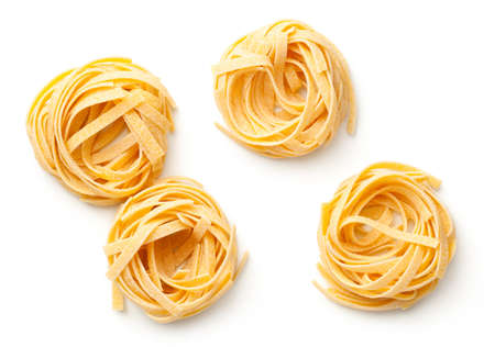 Raw tagliatelle pasta nests isolated on white background. Top viewの写真素材