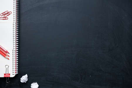 Office supplies on blackboard. Back to school concept background. Copy space. Top view. Flat layの写真素材