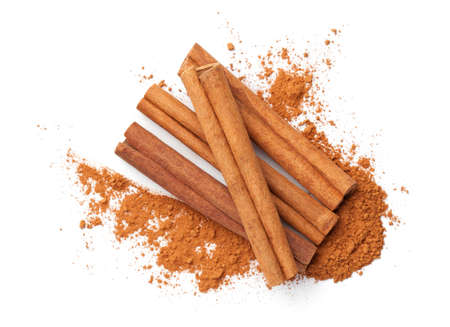 Cinnamon sticks and powder isolated on white background. Top view, flat layの写真素材