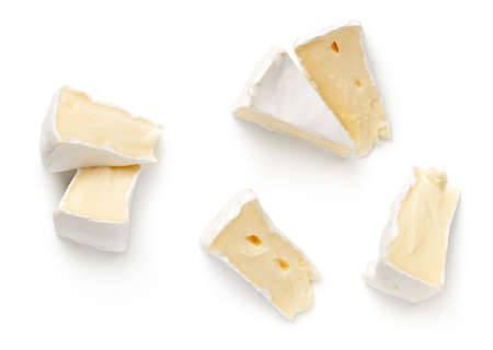 Pieces of camembert cheese isolated on white background. Flat lay. Top viewの写真素材