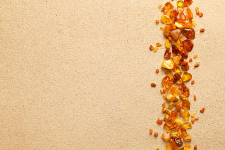 Ambers on sand background. Flat lay, top viewの写真素材