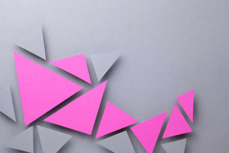 Minimal geometric composition over gray paper  with pink and gray triangular shapes.の写真素材