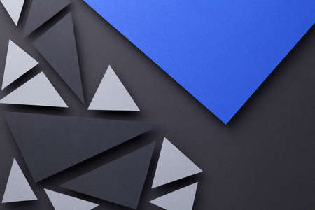 Modern triangular shapes composition over black paper background. Minimal style. Top viewの写真素材