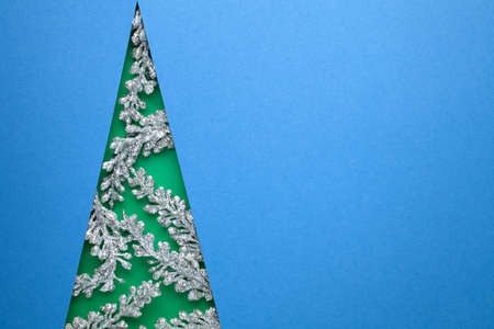 Minimal art design for christmas. Elegance christmas tree concept with silver twigs. Blue...
