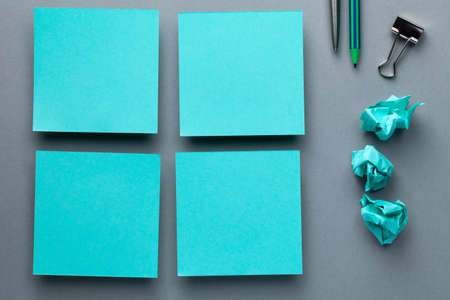 Office minimal concept with azure color paper notes. Copy space. Flat lay, top viewの写真素材