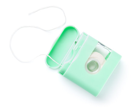Dental floss in green box isolated over white background. View from aboveの写真素材