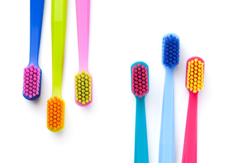Colorful new toothbrushes isolated on white background. Top viewの写真素材