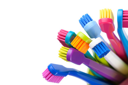 Group of colorful toothbrushes in cup isolated on white background. Top viewの写真素材